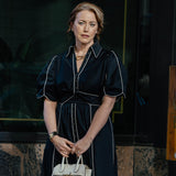 Liliana Weeks carrying Valextra Milano crossbody micro bag in The Madison