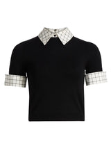 Black shirt with plaid collar and cuffs on a white background