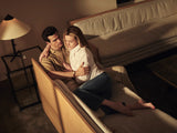 Couple embracing on a couch in a dimly lit room