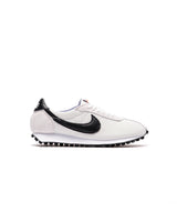 White sneaker with black swoosh logo on a white background