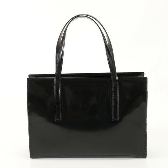 Black handbag with glossy finish on a white background