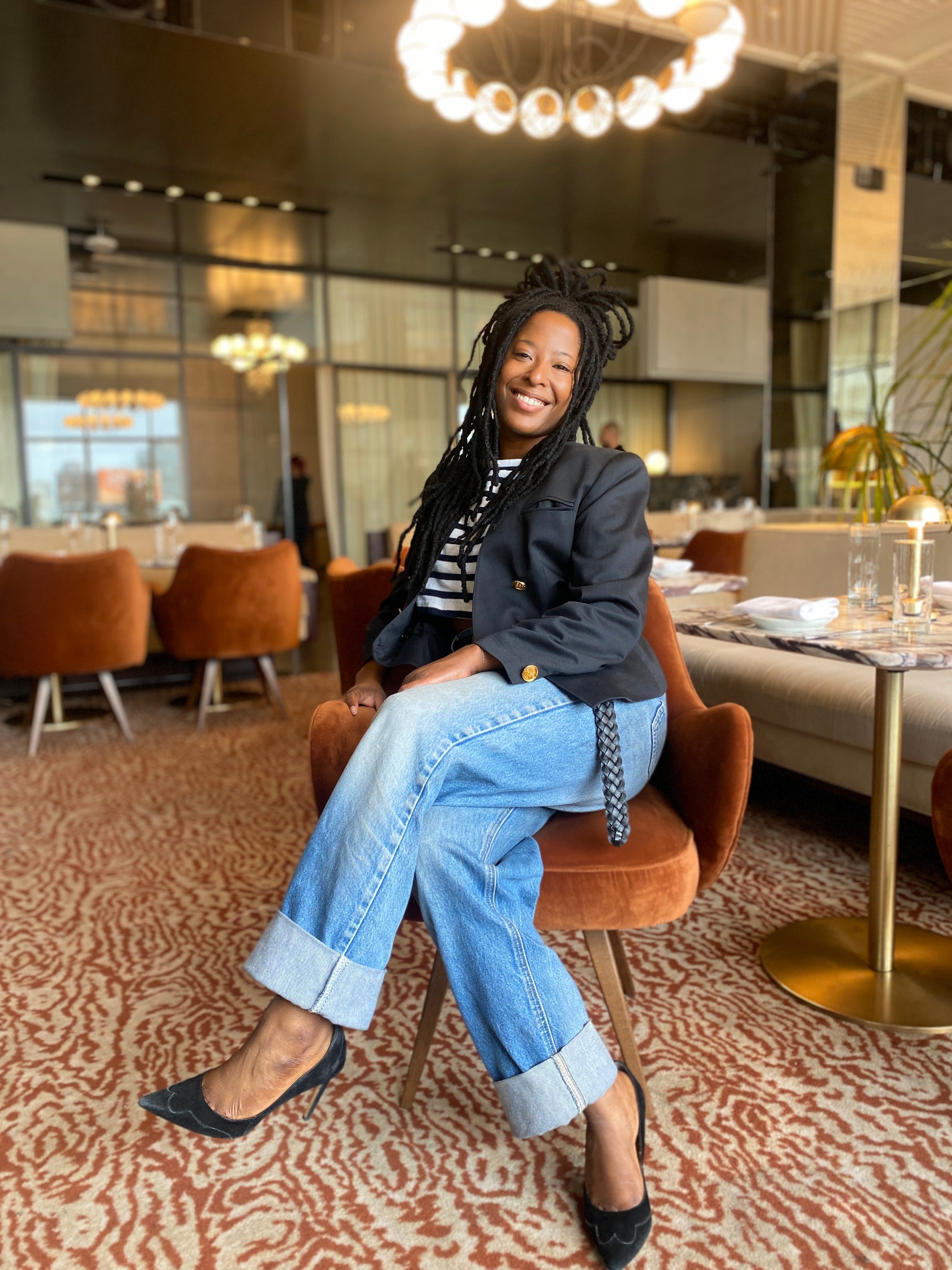 Woman sitting on a chair in a modern restaurant setting