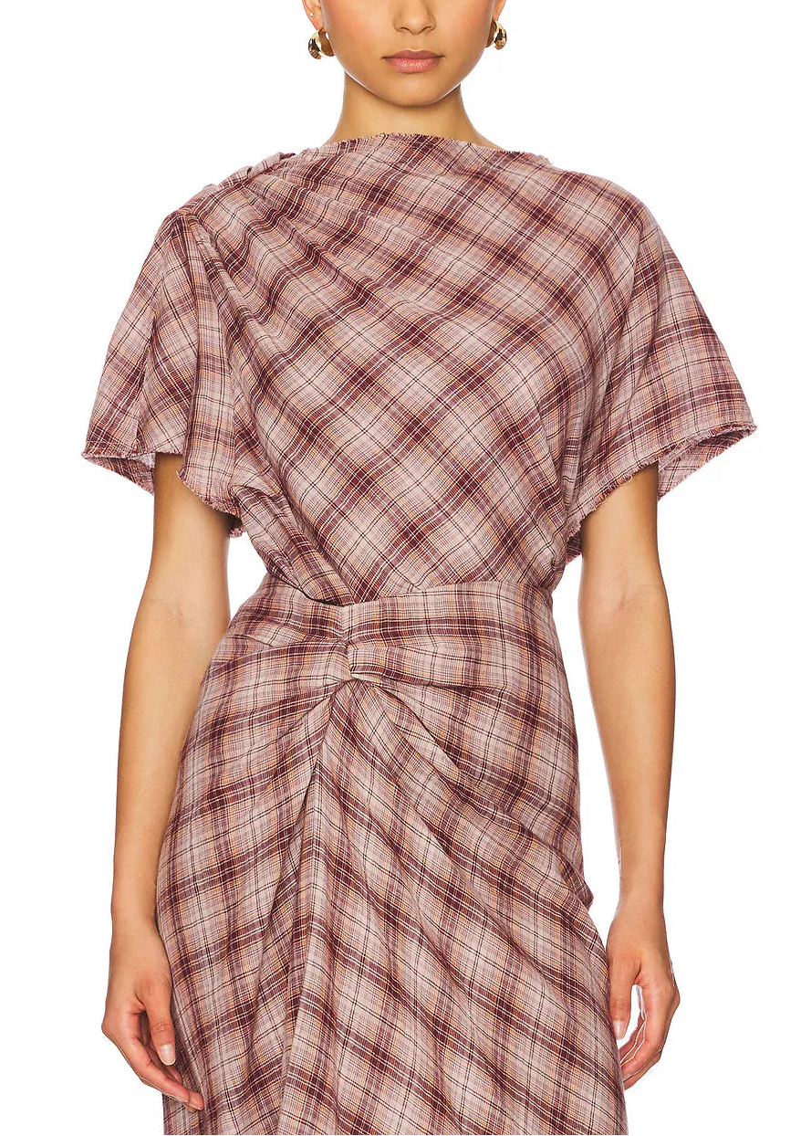 Woman wearing a plaid dress on a white background