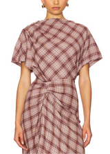 Woman wearing a plaid dress on a white background