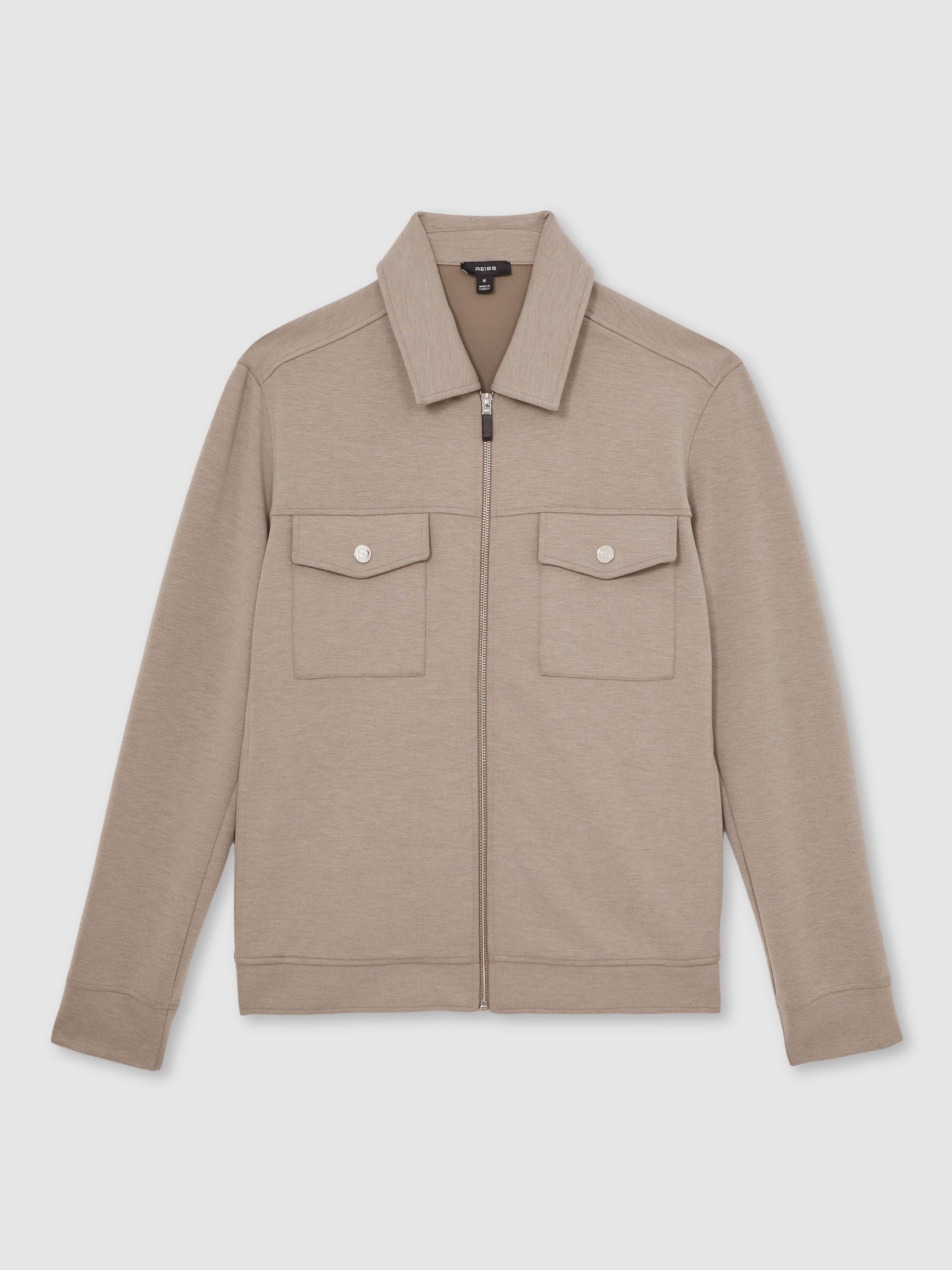 Beige jacket with two front pockets on a light gray background