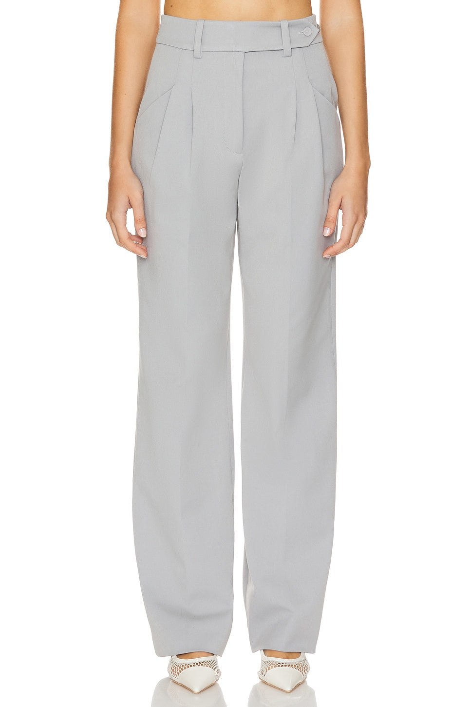 Light gray pants worn by a person on a white background