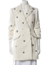 White coat with decorative buttons on a mannequin against a white background