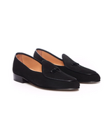 Pair of black loafers on a white background