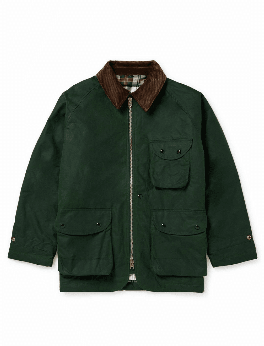 A dark green waxed canvas utility jacket with a brown corduroy collar, featuring a front zipper, chest pocket, and lower flap pockets, shown against a plain white background.