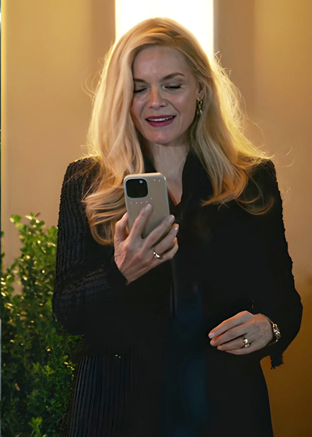 Woman using a phone on a city street at night