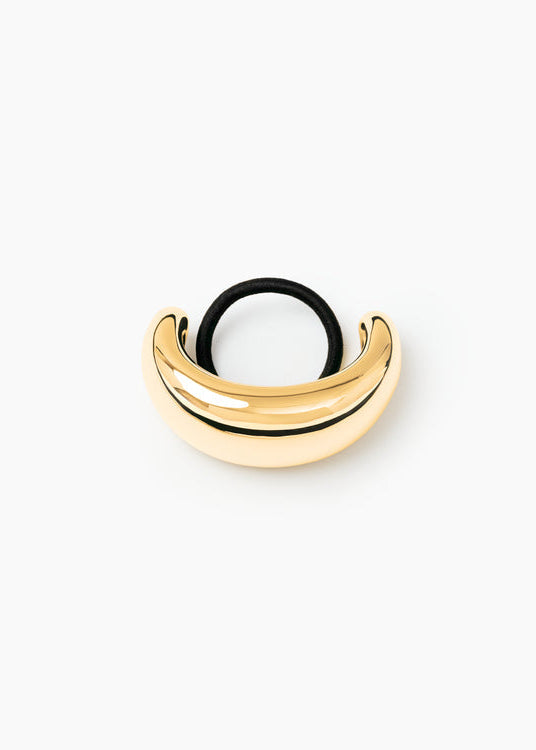 Gold and black hoop earring on a white background