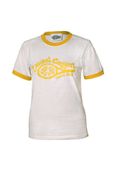 A white ringer t-shirt with yellow trim on the collar and sleeve cuffs, featuring a yellow graphic print on the front that reads 'Laurel Canyon Tennis Club' with a tennis racket and lemon slice design.