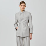 Person wearing a gray suit on a light gray background