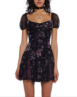 Woman wearing a black floral dress on a white background